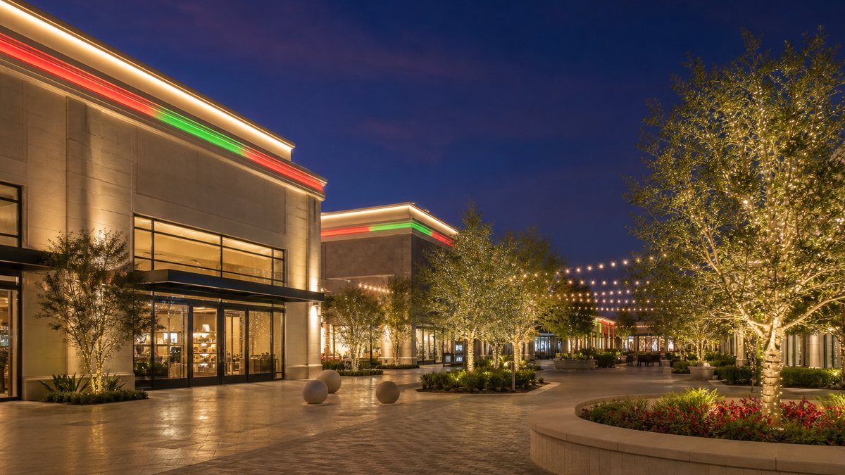Plano Texas open-air shopping center at dusk with permanent LED roofline holiday lighting and lit trees