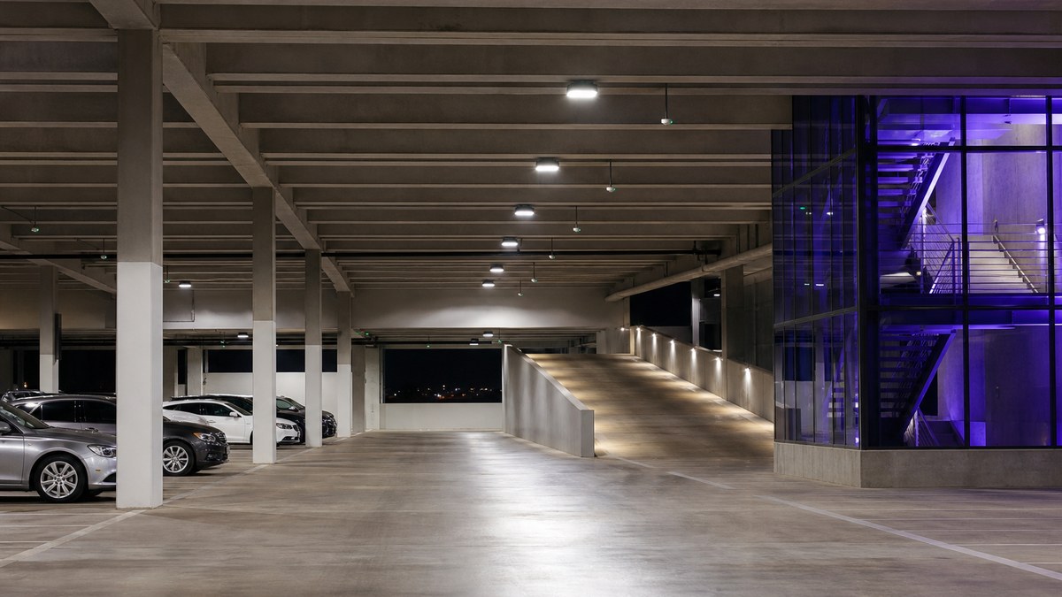 Corporate parking garage in Collin County with even LED lighting and sensor-controlled fixtures at night