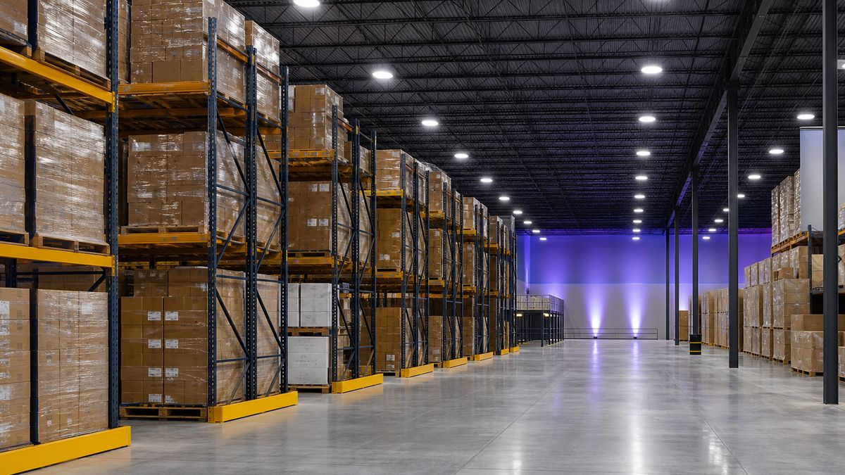 Modern warehouse in Collin County with new LED high bay fixtures installed evenly over racking and aisles